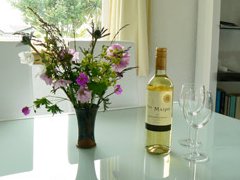 The dining room with flowers and wine on the table